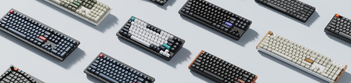Selección de teclados Keychron de distintos formatos, colores y diseños sobre fondo claro